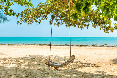 Swing on sand beach at tropical island. Tropical nature landscapeの写真素材