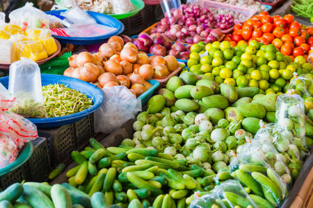 Food market with stall full of asian fruits and vegetables. Thailand fresh groceriesの写真素材
