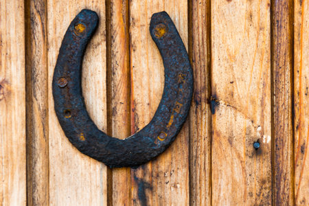Old rustic horseshoe on wooden wall. Rust horse shoe for luckの写真素材