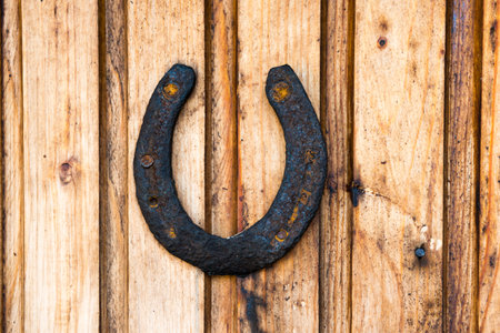 Old rustic horseshoe on wooden wall. Rust horse shoe for luckの写真素材