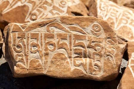 Budhist symbols on Mani Wall in Zanskar Valley Jammu and Kashmir India.の写真素材