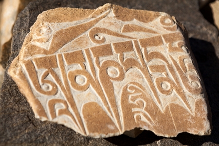 Buddhist symbols on Mani Wall in Zanskar Valley Jammu and Kashmir India.の写真素材