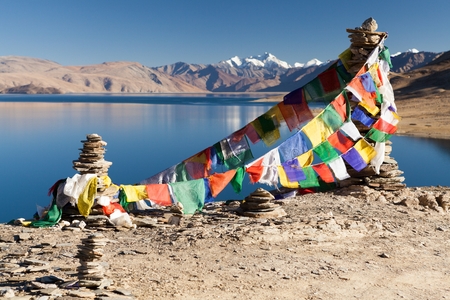 Prayer flags above Himalayan lake Moriri Tso Ladakh Jammu and Kashmir India.の写真素材
