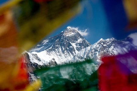 View of Mt. Everest trough prayer flags on summit of Gokyo Ri, Gokyo, Solu Khumbu, Nepal.の写真素材