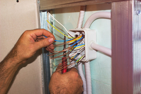 Electricians clears the ends of the wires. installation worksの写真素材
