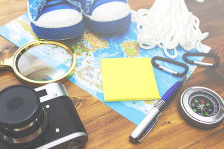 Travel plan. Reminder, camera, compass  and stationery on the tableの写真素材