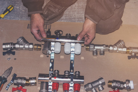 The plumber collects the heating system for the house, plumbing works