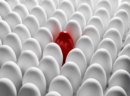 Red egg standing out from the others. Conceptualの写真素材