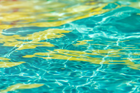 Background of clean water in a blue swimming pool