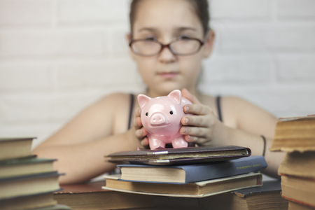 Student holding piggy bankの写真素材