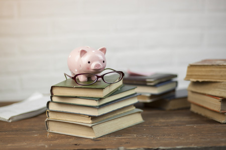 On the table of the book, piggy and the glassesの写真素材