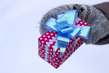 Gift in the hand in winterの写真素材