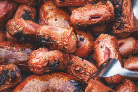 Roasting sausages on the fire, close-up viewの写真素材