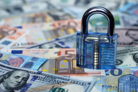 Lock on a background of moneyの写真素材
