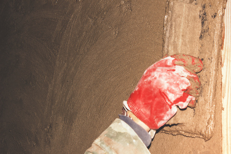 Construction worker plastering concrete wallの写真素材