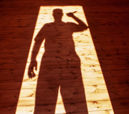 Man hand holding  knife in shadowの写真素材