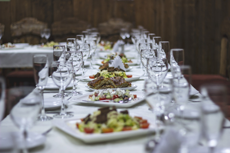 Neatly laid table, white tableclothの写真素材