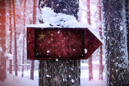 The Chinese flag attached to the tree as a sign.の写真素材