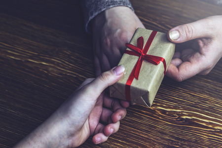 Girl passes a gift to a girlの写真素材