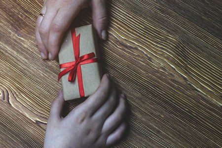Girl passes a gift box to her motherの写真素材