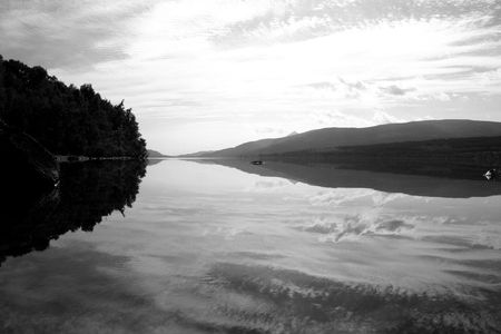 Big sky reflection in Scottish Loch.の写真素材