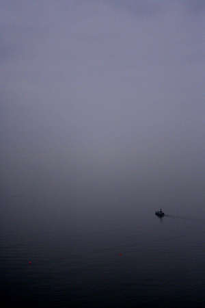 BOAT ON MISTY WATERの写真素材