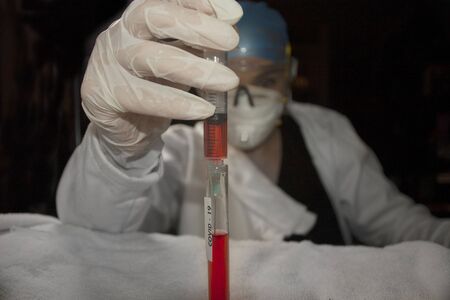 Syringe drawing plasma from the test tube used by the biologist pharmaceutical chemist in search of...