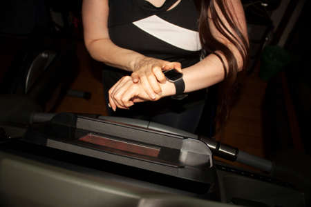 Woman exercising on an elliptical at home or gym to maintain health