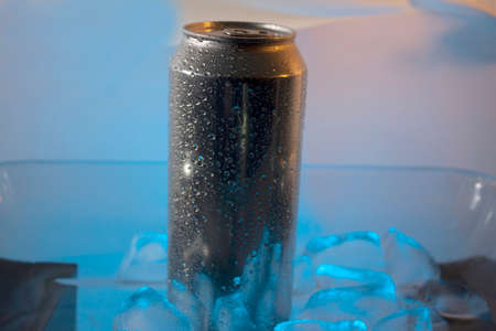 Silver can surrounded by icy droplets standing inside blue ice in Mexico with no people in the sceneの写真素材