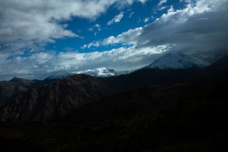 Timid ray of sun that crosses the cloudy sky to illuminate part of the mountain crown of the Andes...
