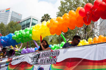 Mexico city, MEXICO - MAY 29, 2019: Allegorical car decorated with balloons that paint Mexico City with the rainbow aboard members of the LGBTTI community in an annual pride marchのeditorial素材