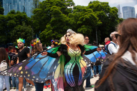 Mexico city, MEXICO - MAY 29, 2019: With a Mariposa costume spreads large wings painting the streets of Mexico City with rainbow color in the LGBTTI pride marchのeditorial素材