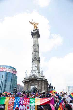 Mexico city, MEXICO - MAY 29, 2019: rainbow umbrellas under the sun carried by the crowd at the LGBTTI pride march in avenue de la reforma Mexico cityのeditorial素材