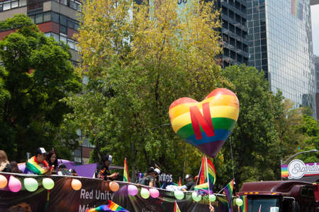 Mexico city, MEXICO - MAY 29, 2019: rainbow umbrellas under the sun carried by the crowd at the...