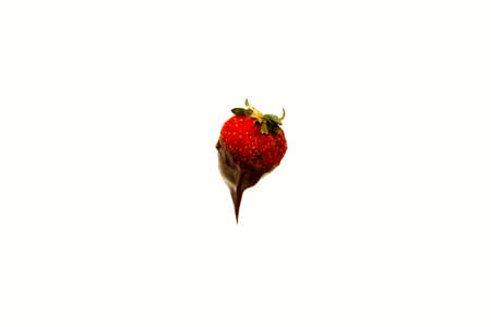 Strawberry with chocolante falling frozen isolated on white backgroundの写真素材