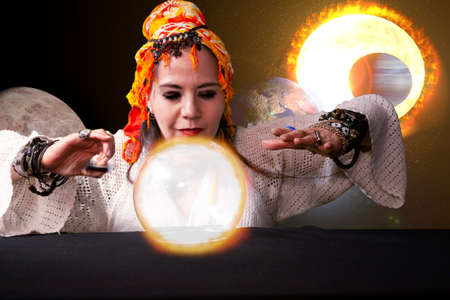 Woman inspired by the planets the earth and the sun reads a crystal ball the Fortune teller expert...