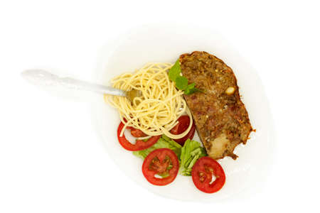 salty spicy slice meatloaf beef dinner served with spaghetti and lettuce salad with tomato