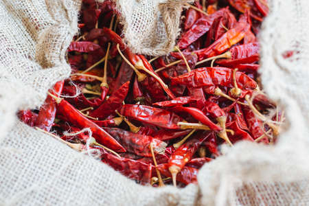 Close up of hot dried chilies  pepper in white sack. Spice ingredient to use for cooking