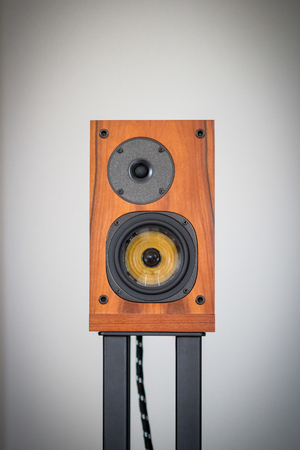 A audio speaker on black stand with speaker wire.の写真素材