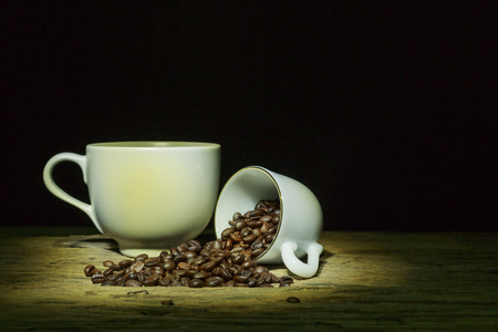 The coffee cups and coffee bean on wood table.の写真素材