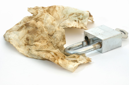 rust wiped and stain onto paper after cleaning rusty key isolated on white background; de-rustingの写真素材