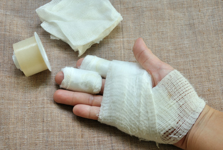 injuery hand  with bandage and first aid tapeの写真素材