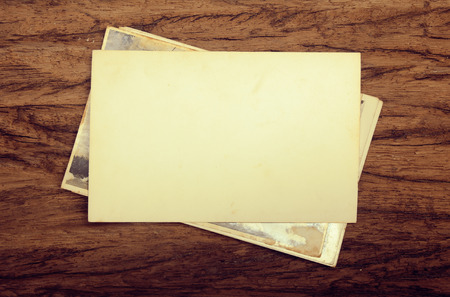 old paper photo frame in vintage style on wood backgroundの写真素材