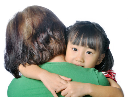 little asian granddaughter in senior woman's armの写真素材