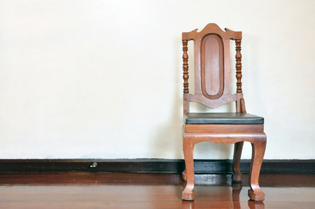 Antique wood chair and clock on wooden floorの写真素材