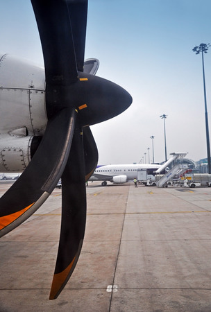 Side propeller of the plane with airplane preparation background at the airportの写真素材