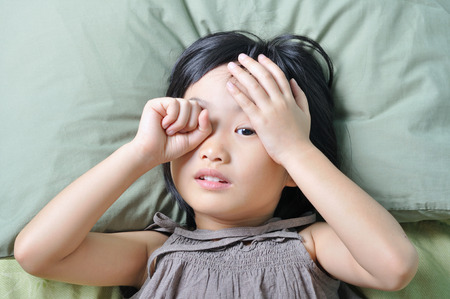 wake up of sleepy asian little childの写真素材