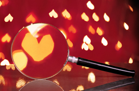 Abstract heart bokeh through magnifying glass.Concept of love, Valentine, soulmate, destiny.の写真素材