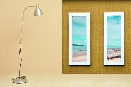 Modern floor lamp against light beige wall with window frame reveal  sea view landscapes. Vacation concept.の写真素材