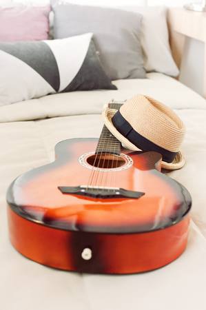 Stylish hipster hat laying on guitar in musician bed.shallow DOF.の写真素材